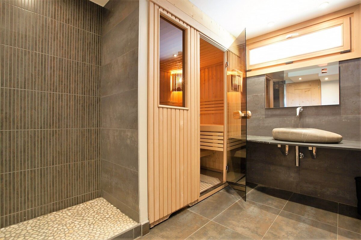 A bathroom with a sauna and a sink