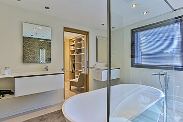 A bathroom with a bathtub and a sink