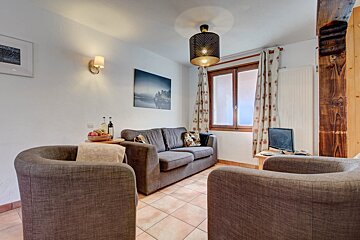 A living room with a couch and two chairs