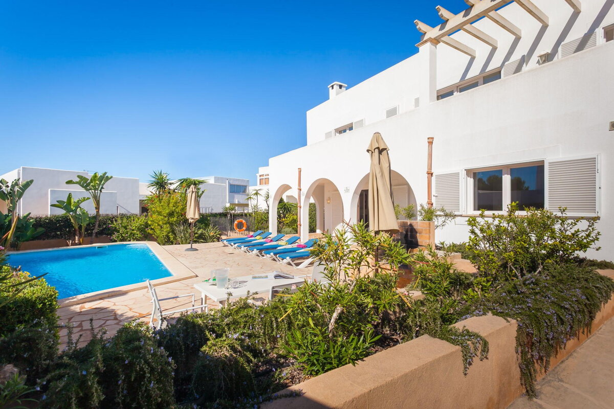 A large white building with a swimming pool in front of it