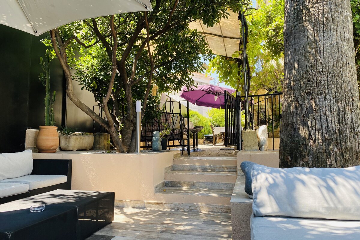 A patio area with a purple umbrella in the background