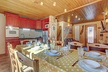 A dining room table with a yellow and white polka dot tablecloth