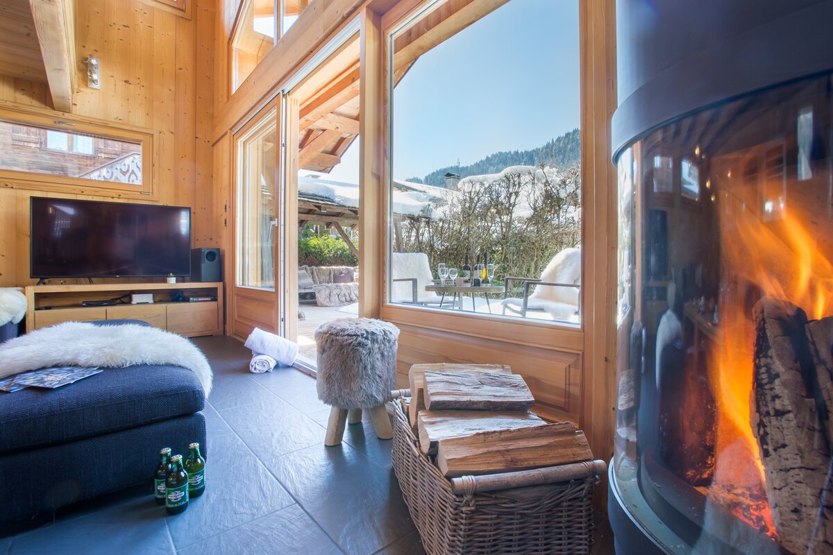 A living room with a fireplace and a television