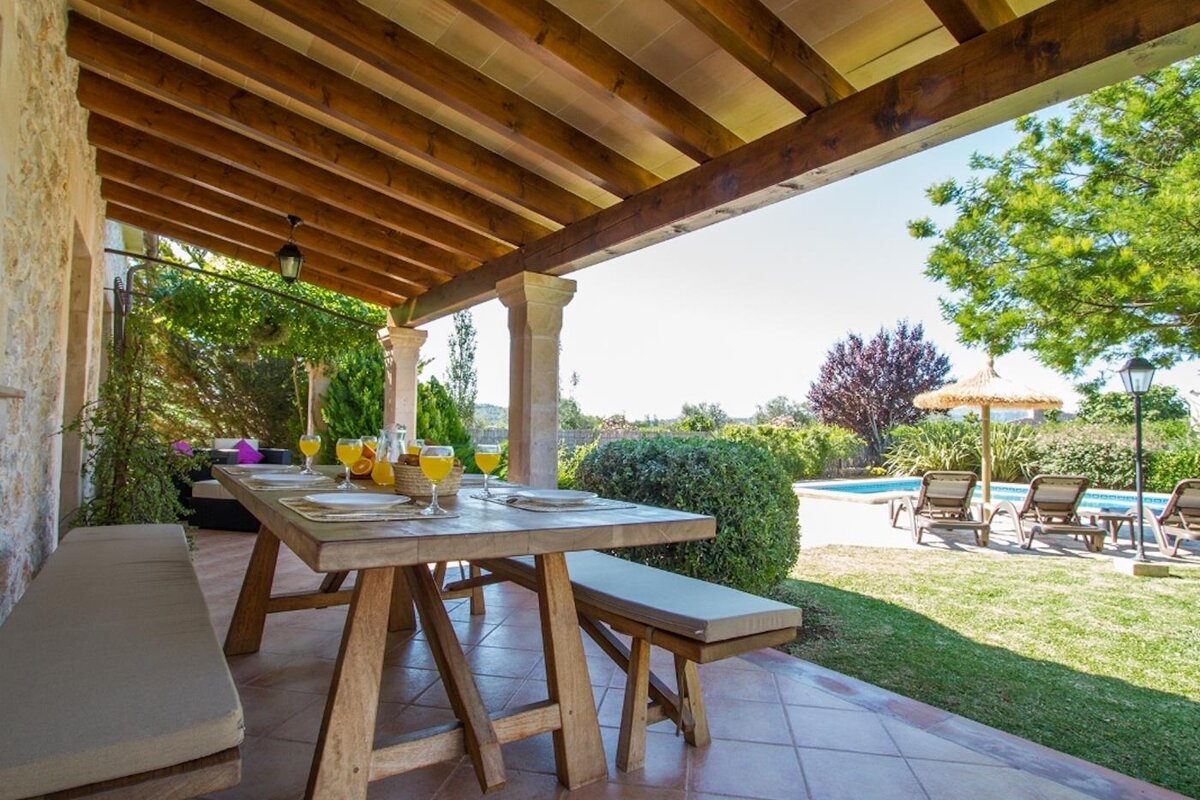 A wooden table with glasses of orange juice on it