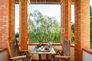 A balcony with a table and chairs and a sign that says homebud