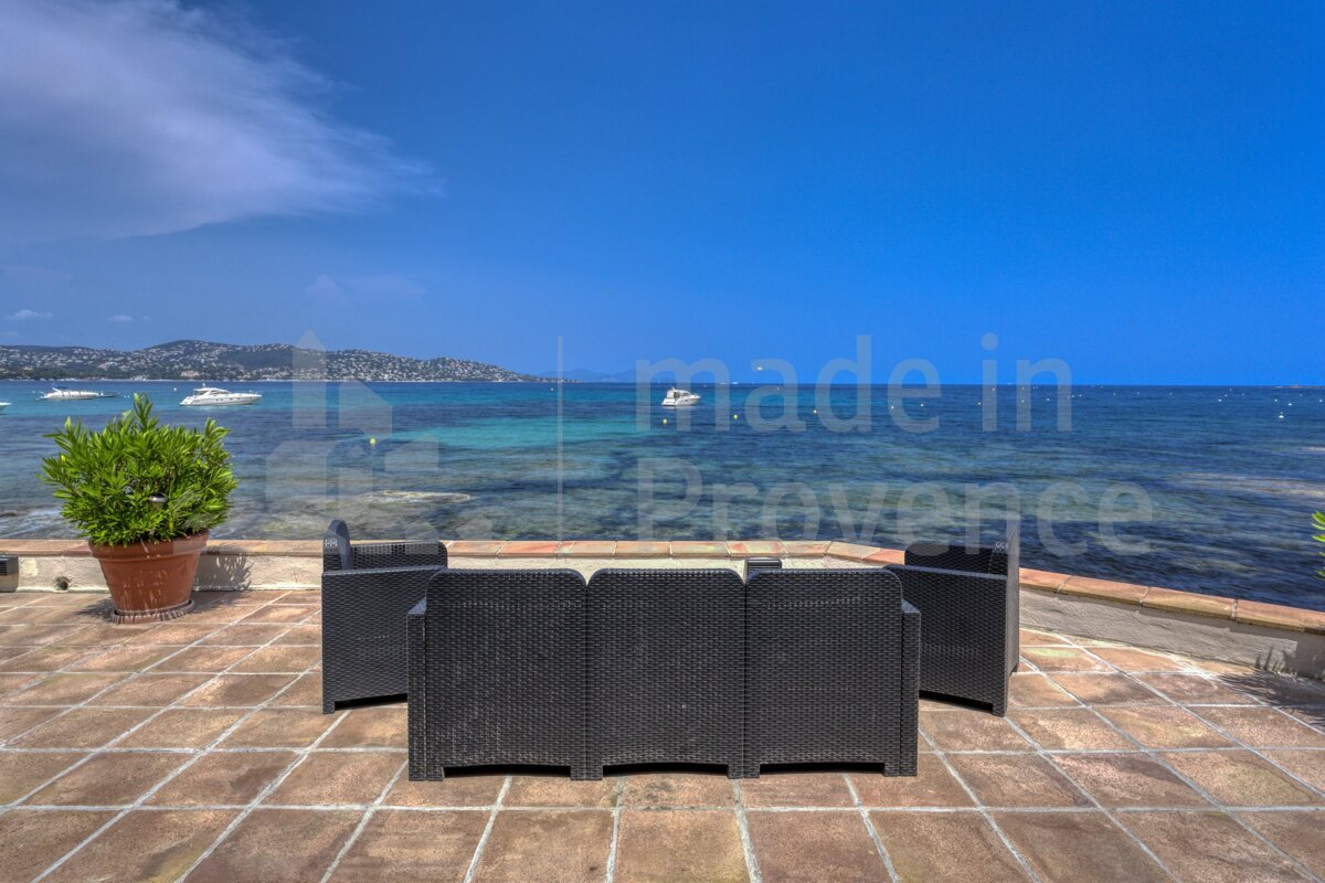 A patio with a view of the ocean and the words made in provence