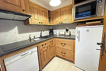 A kitchen with wooden cabinets and a bosch dishwasher