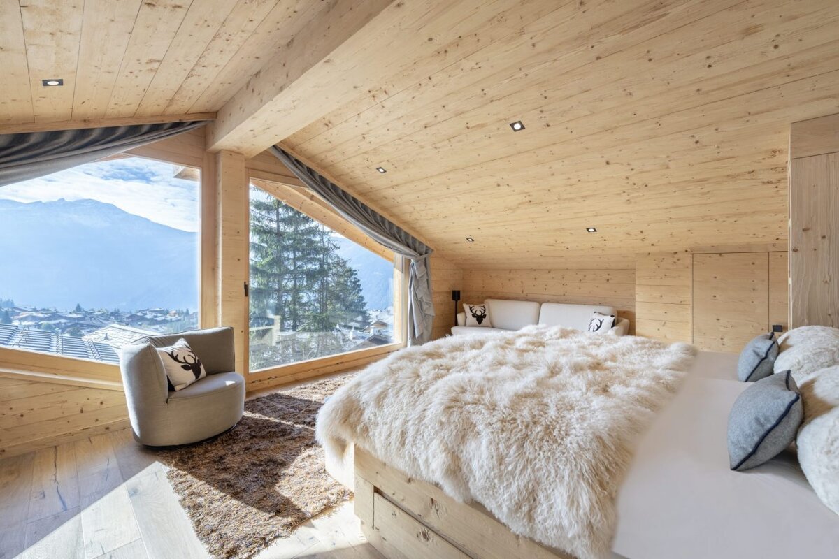 A bedroom with a large bed and a large window