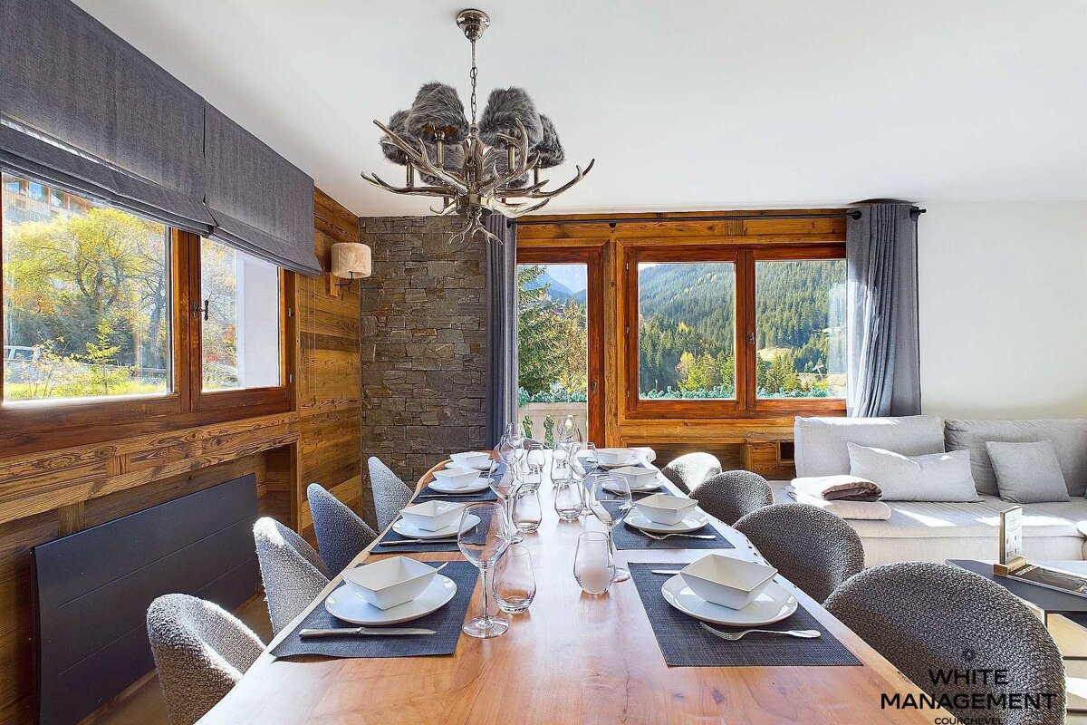 A living room with a couch a table and chairs