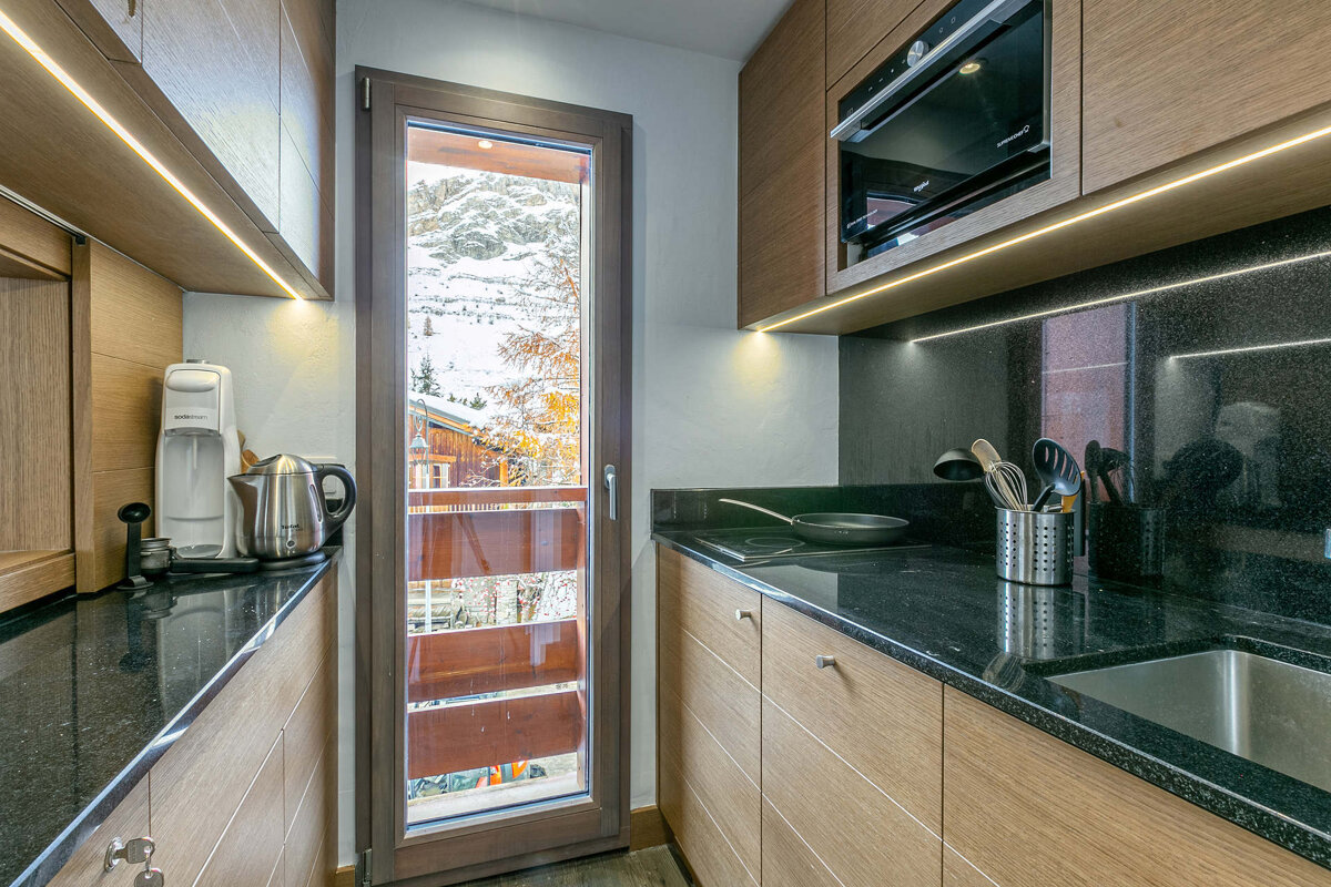 A snowy landscape with a mountain in the background