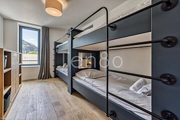Bunk beds in a room with the number 80 on the wall