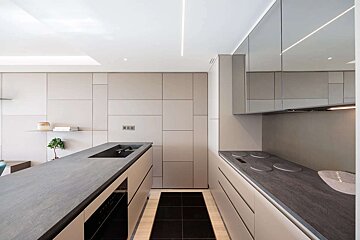 A kitchen with a stove top oven and a sink