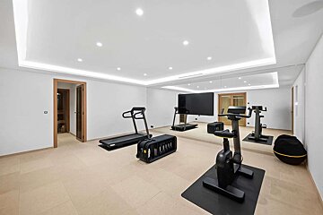 A gym with two treadmills and a bike
