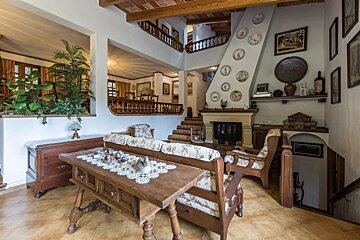 A living room with a fireplace and plates on the wall