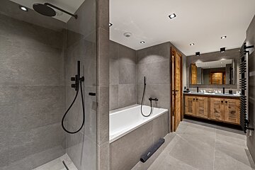 A bathroom with a bathtub and a walk in shower