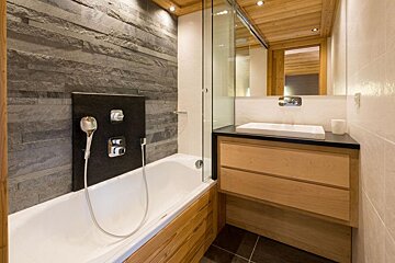 A bathroom with a bathtub and a sink