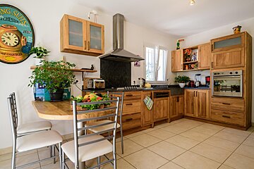 A kitchen with wooden cabinets and a sign that says ' chester ' on it