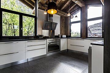 A kitchen with white cabinets and a stove that says 00000 on it