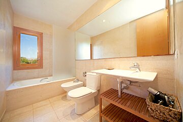 A bathroom with a sink toilet and bathtub