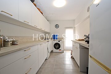 A kitchen with the word home on the counter