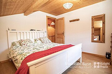 A bedroom with a bed and a mirror from mountain base knight frank