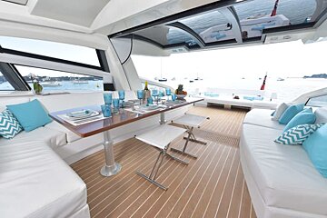 The inside of a boat with a table and chairs
