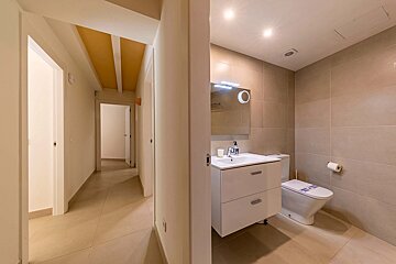 A bathroom with a toilet a sink and a mirror