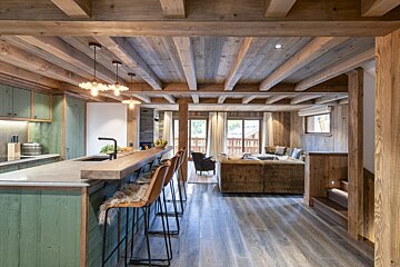 A kitchen with green cabinets and a wooden ceiling