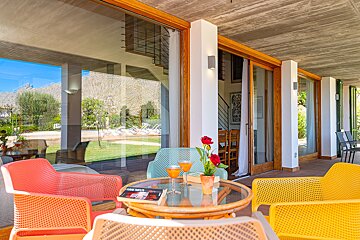 A table with two glasses of wine and a book on it