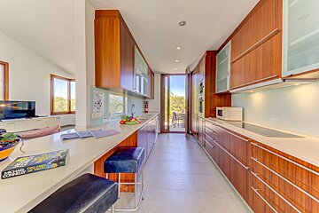 A kitchen with wooden cabinets and a sign on the counter that says ' a game of chess '