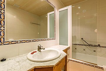 A bathroom with a sink a mirror and a bathtub