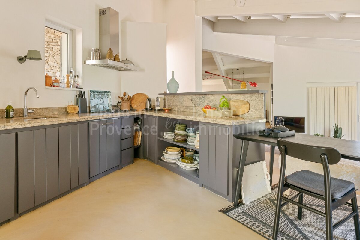 A kitchen with a counter top that says provence immobiliere