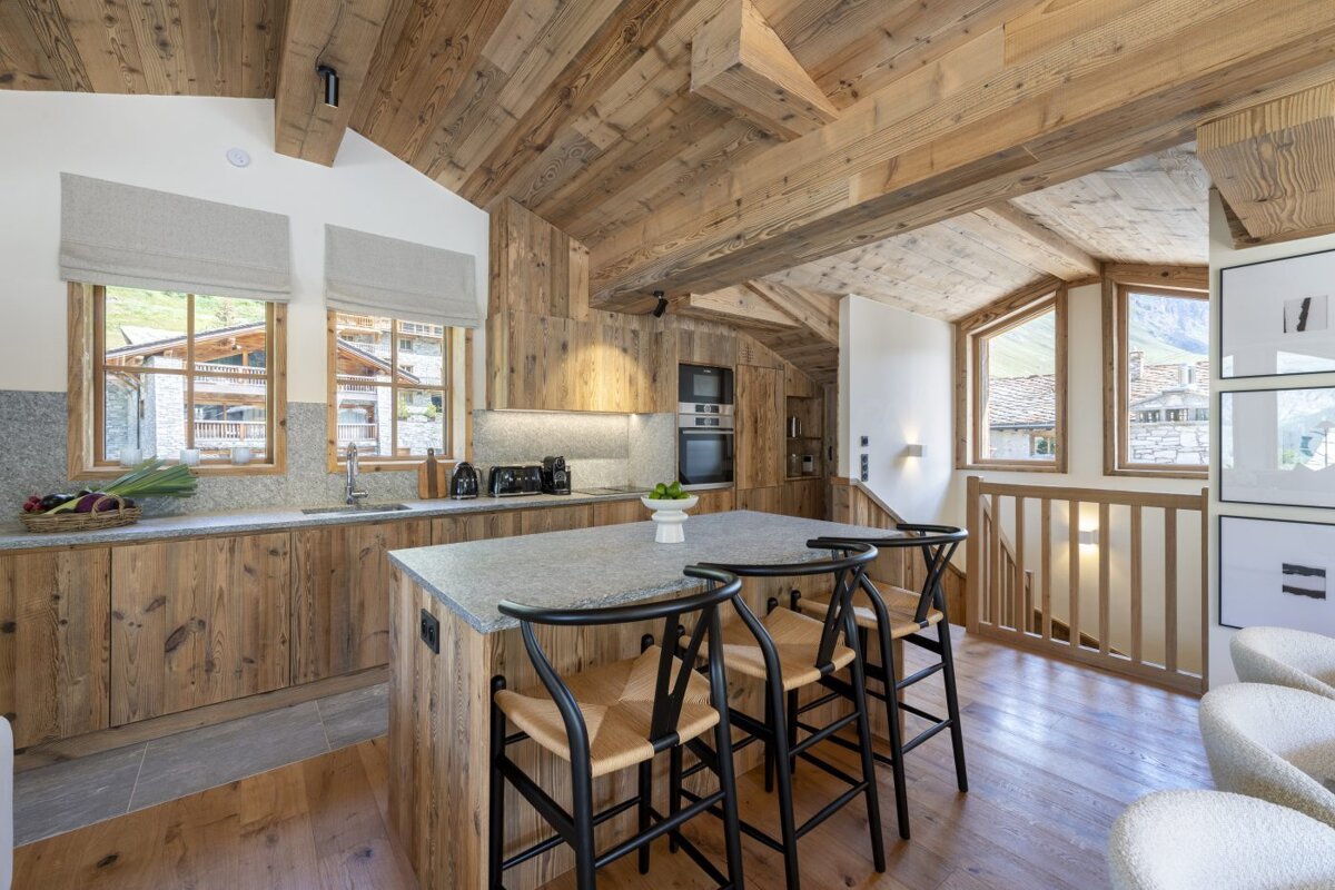 A kitchen with wooden cabinets and a granite counter top