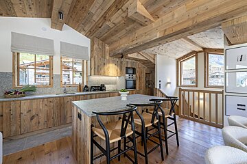 A kitchen with wooden cabinets and a granite counter top