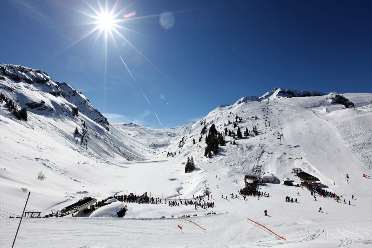 A ski lift is going up a snowy mountain