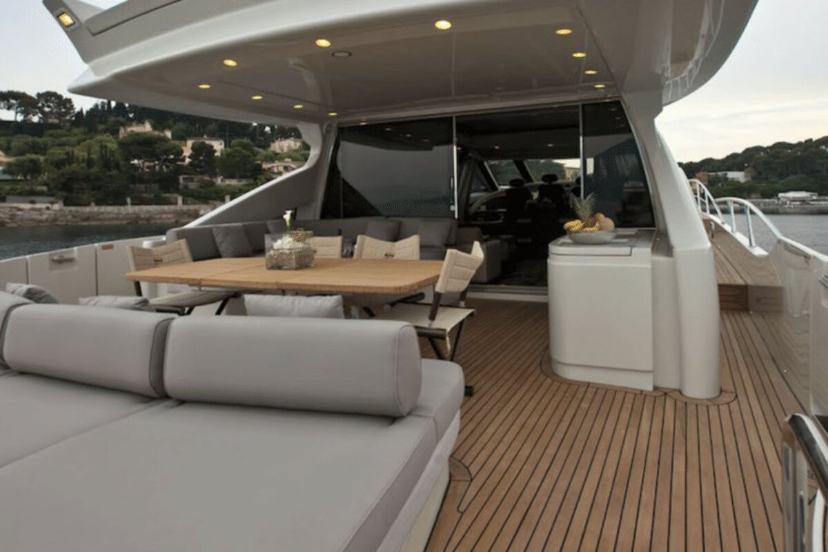 A boat with a table and chairs on the deck