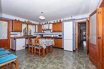 A kitchen with a table and chairs and a siemens refrigerator