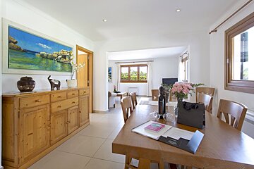 A swimming pool with a white umbrella in front of it