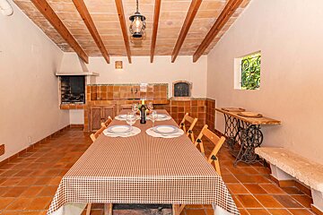 A table with a checkered tablecloth and a bottle of wine on it