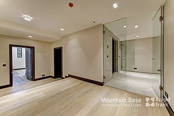An empty room with a sign that says mountain base immobilier real estate