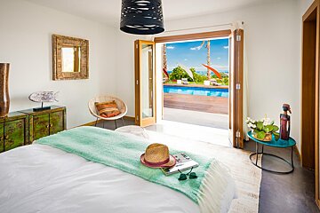 A bedroom with a view of a swimming pool