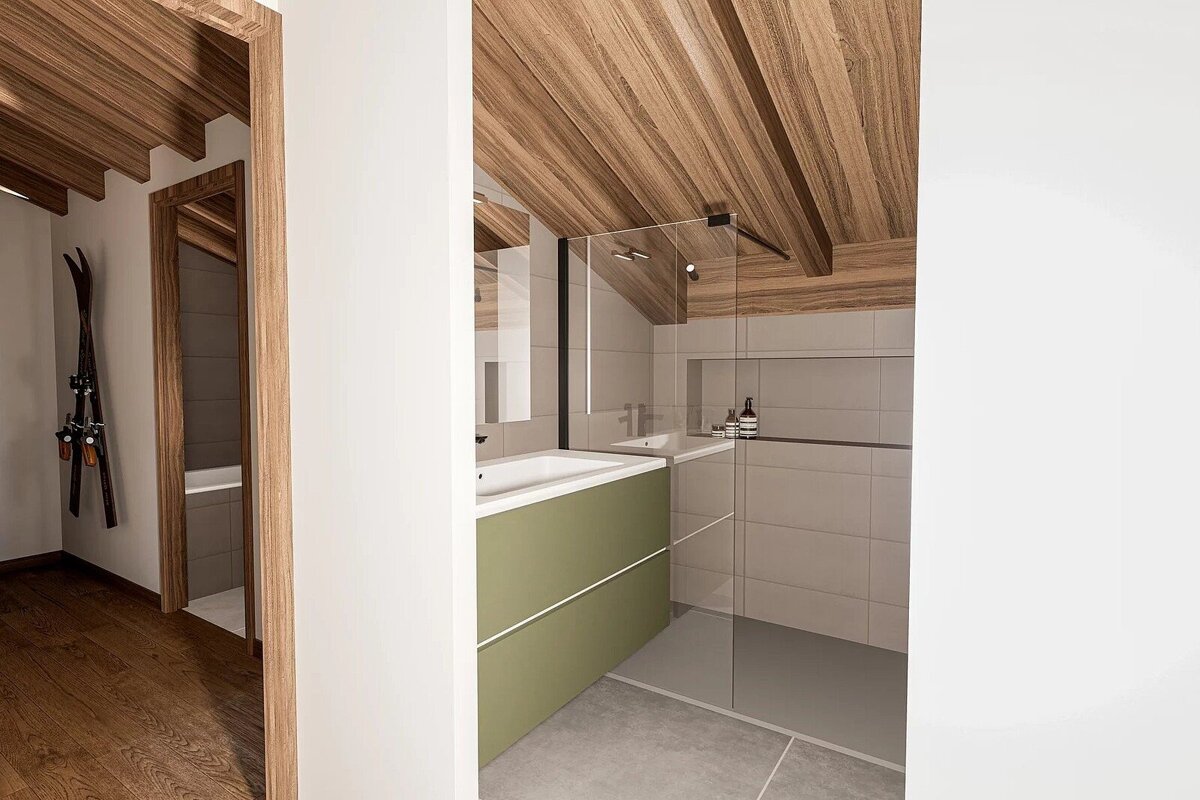 Chic modern bathroom with wood-beamed ceiling, green vanity, and glass shower, seen from a hallway with skis mounted on the wall.