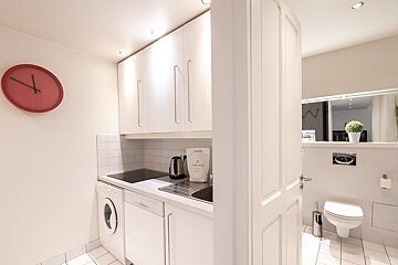 A kitchen with a clock on the wall that shows the time as 4:20