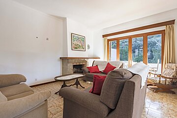 A living room with a fireplace couch and chairs