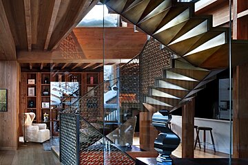 A staircase in a house with a glass railing