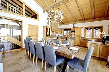 A dining room table with plates and glasses on it