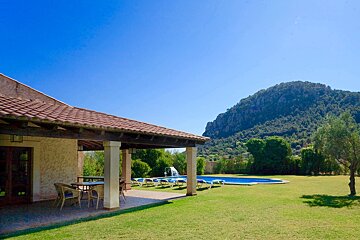 A house with a pool and a mountain in the background