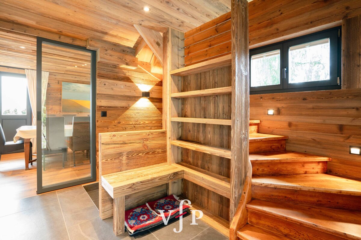 A wooden staircase with a vp logo on the bottom