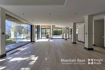An empty room with a mountain base logo on the wall