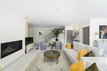 A living room with a couch and a fireplace and a sign that says immobilier